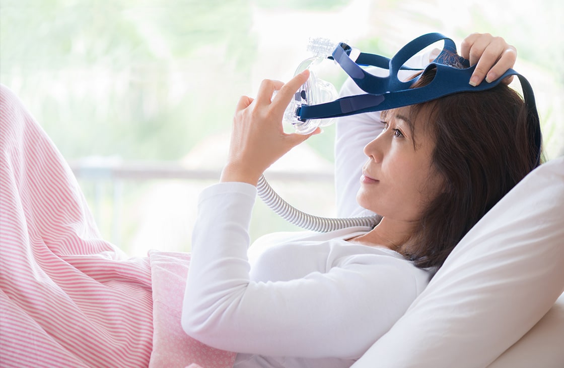 Patient Putting on CPAP